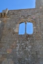 Detailed view of a gothic window, manuelino style, on interior ruins of the medieval Belmonte Castle, iconic monument building on