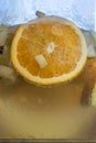 Detailed view at the jar with sliced orange, apple, and cucumber, on champagne sangria drink