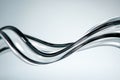 Abstract close-up of intertwined metallic tubes against a neutral background Royalty Free Stock Photo