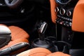 Detailed view of luxury leather salon of luxury convertible sport car in bright orange color. Focus on transmission with Royalty Free Stock Photo