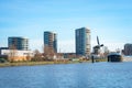 Modern apartments, old windmill and ship in Gouda, The Netherlands Royalty Free Stock Photo
