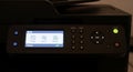 Close Up of a Modern Multifunction Printer Panel with Illuminated Display and Buttons in a Dark Office Setting Royalty Free Stock Photo