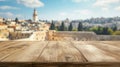A detailed view of an old, empty wooden table, with the Wailing Wall in Jerusalem softly blurred in the background. Royalty Free Stock Photo