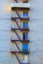 Detailed view of old rusty fire escape to the floors is located near the wall of the building Royalty Free Stock Photo