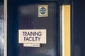 Detailed view of an opened Training Room door which leads to a school classroom.