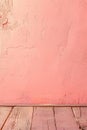Detailed View of a Pink Wall Meeting a Textured Wooden Floor