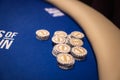 Close Up of Poker Table with Olympic Casino Chips on Blue Felt Royalty Free Stock Photo