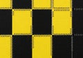 Close up of a yellow and black checkered pattern with a textured surface isolated on white background Royalty Free Stock Photo