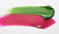 Detailed view of shiny pink and green brushstrokes intersecting on a white backdrop Royalty Free Stock Photo