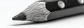 Close View of an Intricately Sharpened Pencil Resting on a White Surface Capturing the Textures and Details of Its Royalty Free Stock Photo