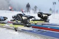 Detailed view of the ski bindings and skis lying on the piste