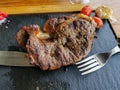 Detailed view of a sliced portion beef on fork, grilled beef steak with great aspect as background