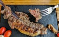 Detailed view of a sliced portion beef on fork, mashed potatoes and beans rice, grilled beef steak with great aspect as background