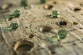 Detailed view of a small glass fragment resting on a wooden table, Bullet holes scattered across a paper target Royalty Free Stock Photo