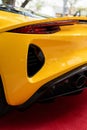 Detailed view of sports car's exhaust pipe and ventilation scoops located below tail light with extraordinary shape Royalty Free Stock Photo