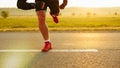 Detailed view of a sprinter getting ready to start. Selective focus.Beautiful field and light sun in a background. Royalty Free Stock Photo