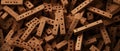 A detailed view of a stack of bricks featuring distinct holes throughout their surfaces.