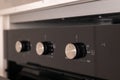 Close-up of oven temperature control knobs in a modern kitchen interior Royalty Free Stock Photo