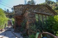 Detailed view of a traditional schist house on Piodao village, tourists visiting and walking on rustic path