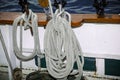 Detailed view of various ropes hanging on the side of tall ship port wall