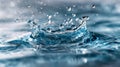 Detailed view of water splash forming ripples and droplets with a soft blue background capturing the dynamic motion of liquid in a Royalty Free Stock Photo