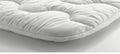 Detailed view of white mattress protector on the bed for enhanced search relevance