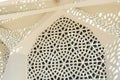 Detailed view of a white wall with traditional Islamic architectural pattern