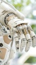 Detailed white robotic arm and hand with visible wires and joints, suggesting advanced future technology and space exploration. Royalty Free Stock Photo