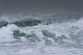 Detailed winter storm wave breaking and splashing on shore