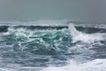 Detailed winter storm wave breaking and splashing on shore Royalty Free Stock Photo