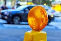 Detailed a yellow warning orange construction light mounted on barricade intended for purpose of warning construction Royalty Free Stock Photo