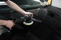 Detailer working with a Rupes rotary machine on a car panel