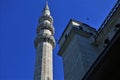 Details of the architecture of the mosque. A tall white stone minaret with a sharp spire. Royalty Free Stock Photo