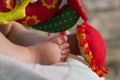 Details of baby boy foot sleeping near multicolored toys