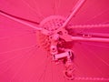 Details of a bicycle painted in pink color. rear derailer