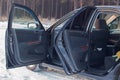 Details of the black car in the cabin, steering wheel, trunk, speedometer and open doors Royalty Free Stock Photo