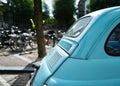Details on a blue classic car Fiat 500 near a canal in Amsterdam