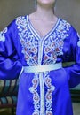 Details of a blue Moroccan caftan for women, and golden lace