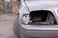 Details of a car accident, close-up of a broken car headlight