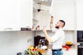 Details of chef cooking in new modern kitchen, pouring alcohol in glass