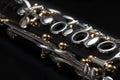 Details of a clarinet with silver keys and golden sockets Royalty Free Stock Photo