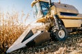 Details of Combine harvesting corn, working the fields during autumn harvest Royalty Free Stock Photo