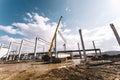 Details of construction site with crane lifting prefabricated concrete framework, unloading and cargo details Royalty Free Stock Photo