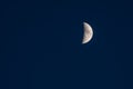 Details of a crescent moon on a clear blue sky Royalty Free Stock Photo