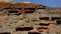 Details of the damaged brick wall structure, partially hollowed stucco