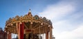 Vintage carousel ride spins in the air at sunset