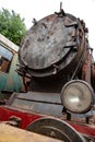 Entrance hatch of rusted steam boiler in old train locomotive at