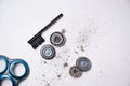 Details of a disassembled dirty shaver head and a cleaning brush on a light background. Soft selective focus. Copy space