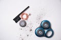 Details of a disassembled dirty shaver head and a cleaning brush on a light background. Soft selective focus. Copy space