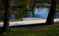 Details of the edge of the pond with paved banks flat stones. curved shape. the path is lined with weeping willows and the sluice Royalty Free Stock Photo